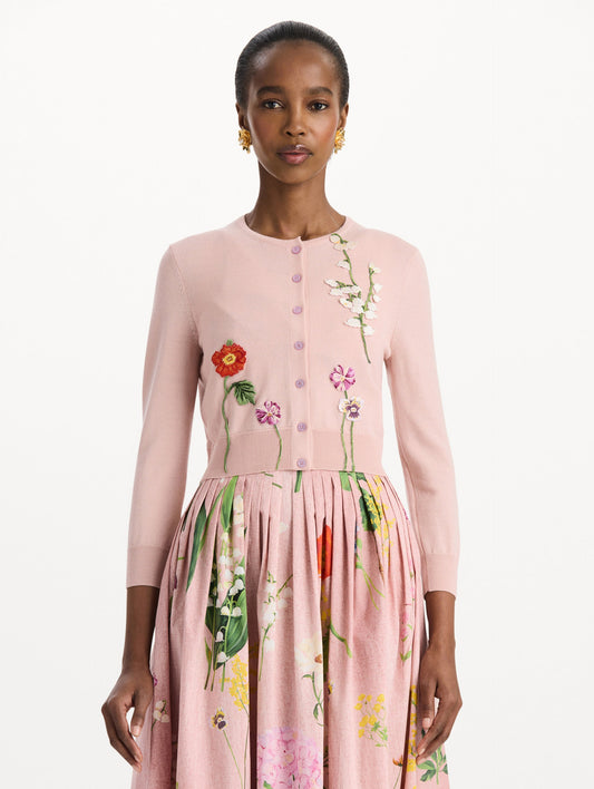 The model is wearing the mixed botanical threadwork cardigan in the color blush with floral detailing. Front view.