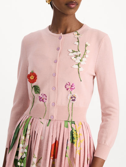 The model is wearing the mixed botanical threadwork cardigan in the color blush with floral detailing. Zoom view.
