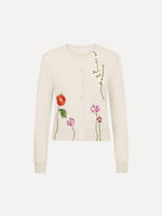 The model is wearing the mixed botanical threadwork cardigan in the color ivory.