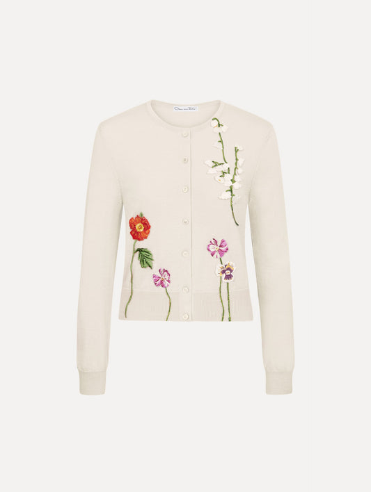 The model is wearing the mixed botanical threadwork cardigan in the color ivory.