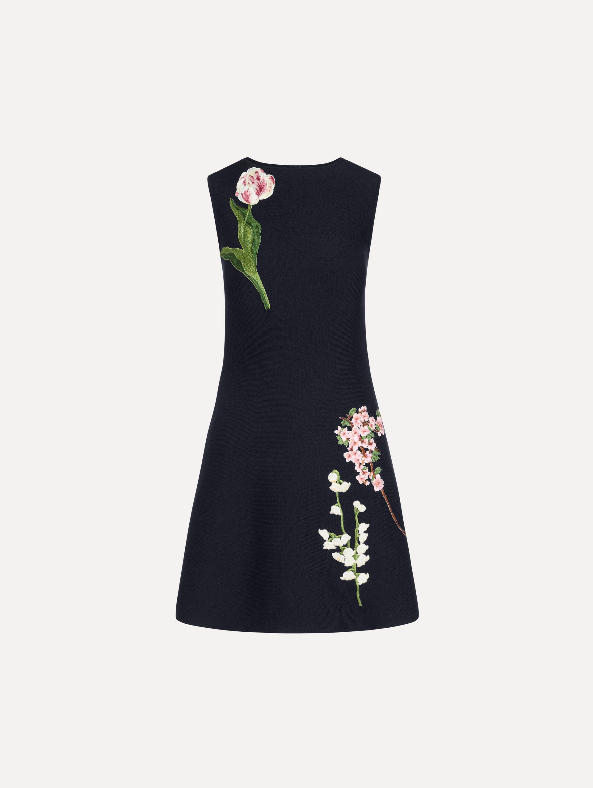 The model is wearing the mixed botanical embroidered dress with an A-line silhouette in a navy wool blend.