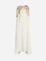 The model is wearing the mixed botanical embroidered georgette caftan with long sleeves in the color ivory.