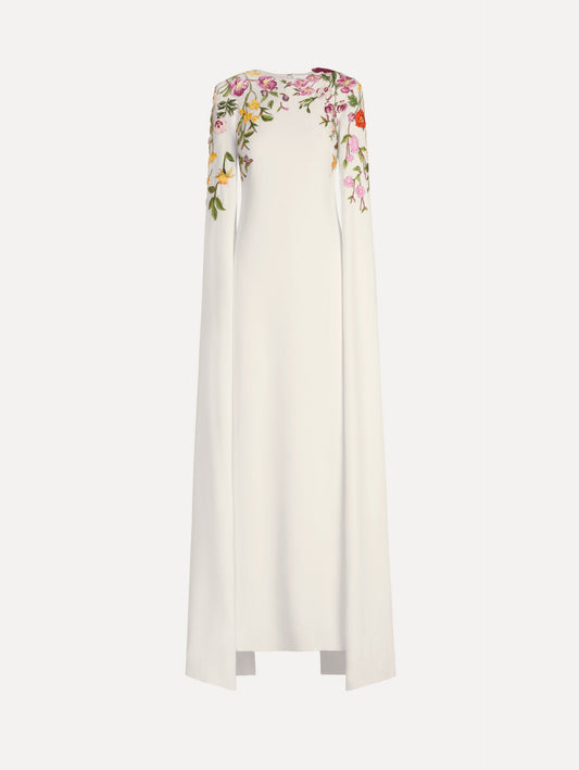 The model is wearing the mixed botanical embroidered georgette caftan with long sleeves in the color ivory.