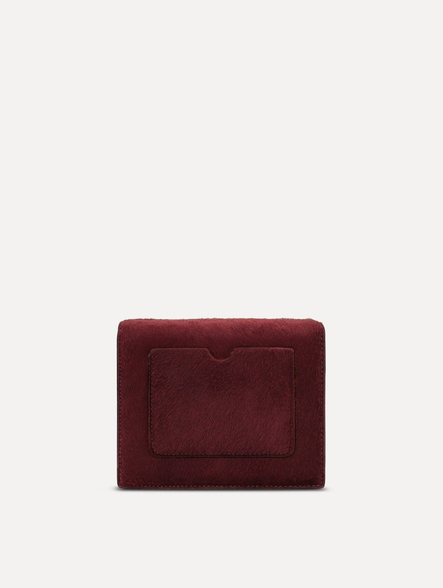 The Haircalf Mini TRO Bag in the color bordeaux. Back view.