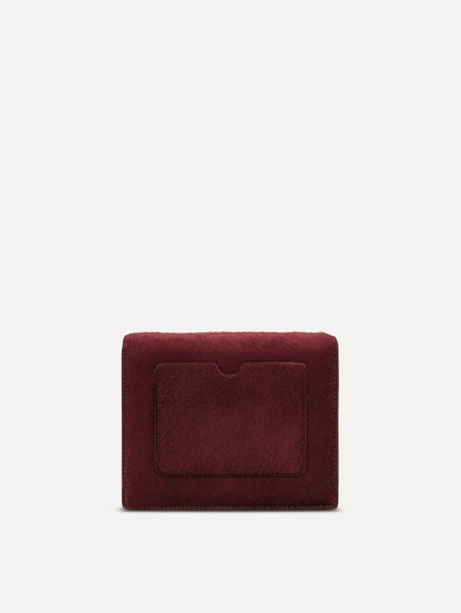 The Haircalf Mini TRO Bag in the color bordeaux. Back view.
