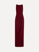 The model is wearing the drape-detailed cady gown with a sleeveless silhouette in the color claret.