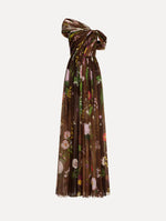 The model is wearing the mixed botanical silk chiffon gown with a one-shoulder neckline and a painterly floral print in a brown multi palette.