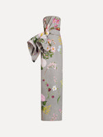 The model is wearing the mixed botanical drape-detailed faille gown with a strapless silhouette in the color grey multi.