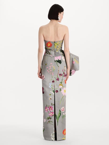 The model is wearing the mixed botanical drape-detailed faille gown with a strapless silhouette in the color grey multi. Back view.