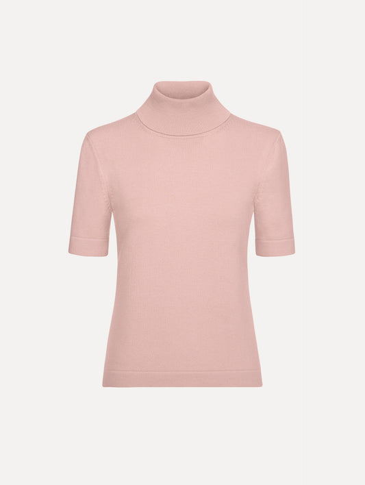 The model is wearing the turtleneck wool short-sleeve pullover with a fold-over neckline in the color blush.