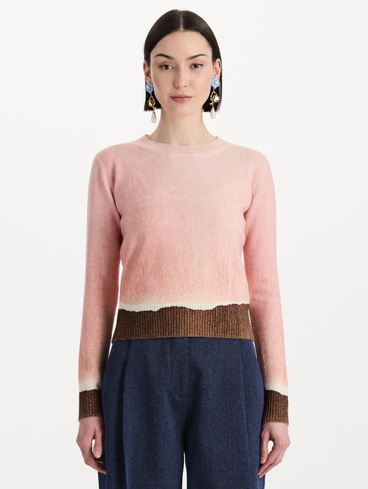 The model is wearing the ombré crewneck pullover with a painterly print in a pink and brown palette. Front view.