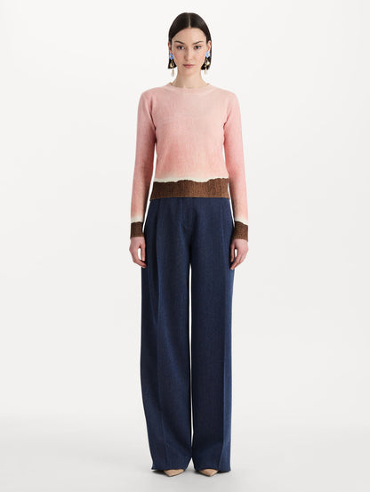 The model is wearing the ombré crewneck pullover with a painterly print in a pink and brown palette. Zoom view.
