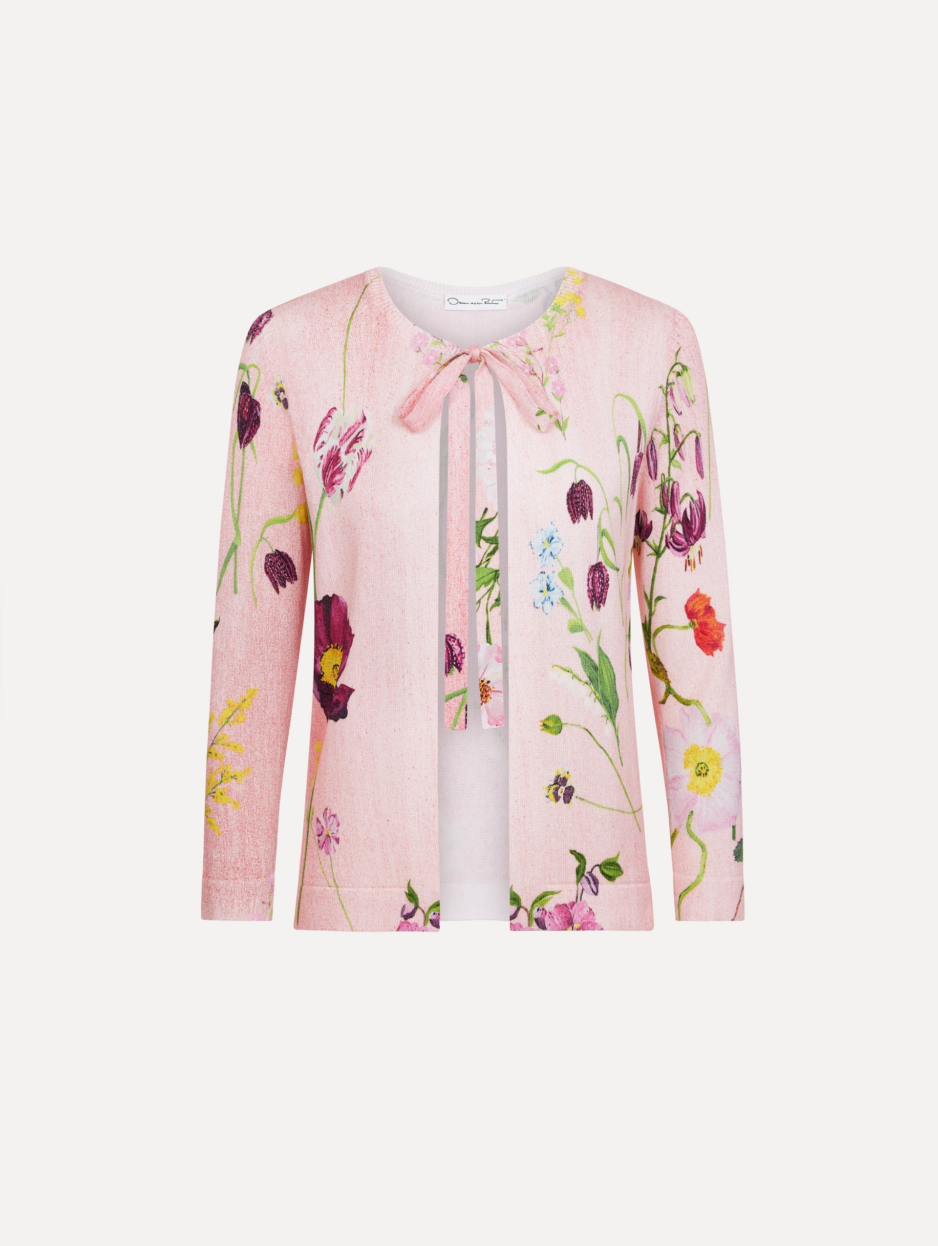 The model is wearing the mixed botanical tie-neck cardigan with an all-over floral print in blush multi.