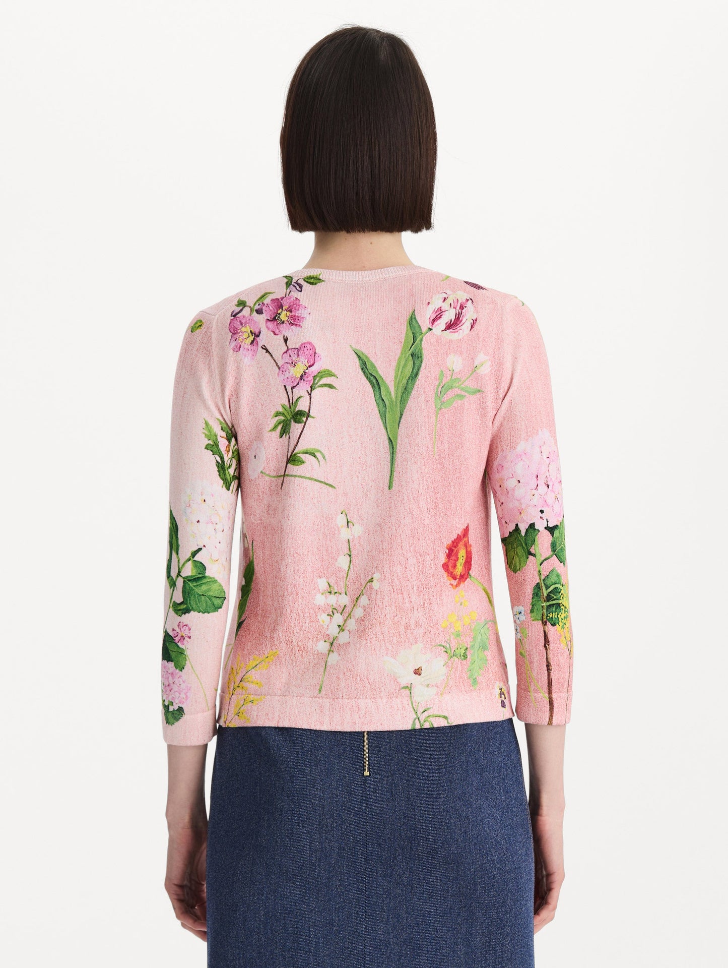 The model is wearing the mixed botanical tie-neck cardigan with an all-over floral print in blush multi. Back view.