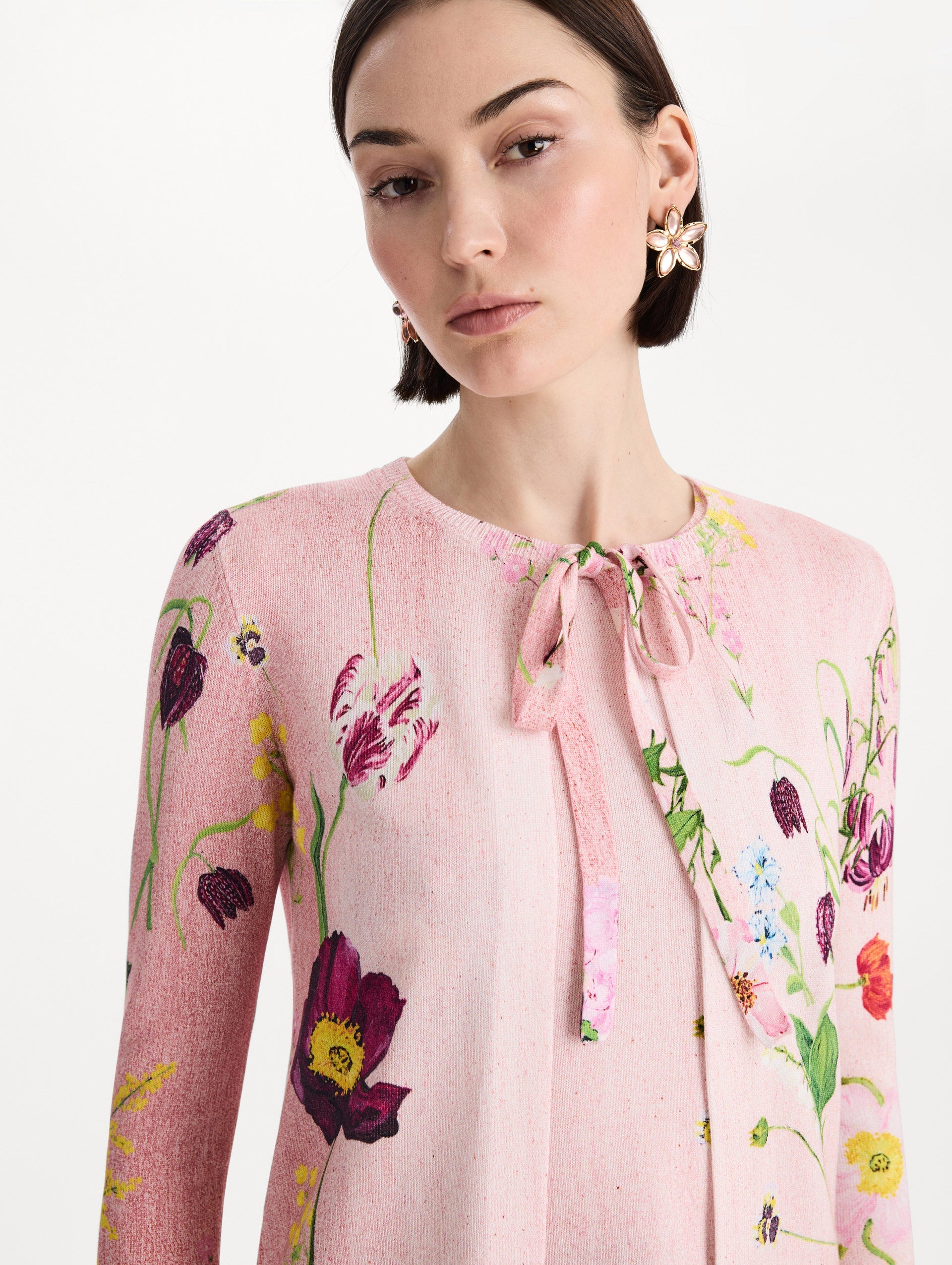 The model is wearing the mixed botanical tie-neck cardigan with an all-over floral print in blush multi. Zoom view.