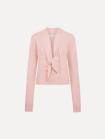 The model is wearing the tie-neck cardigan in blush wool with a tie V-neck detail.
