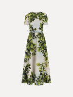 The model is wearing the maple leaves cotton poplin dress with short sleeves and an all-over foliage print in the color green multi.