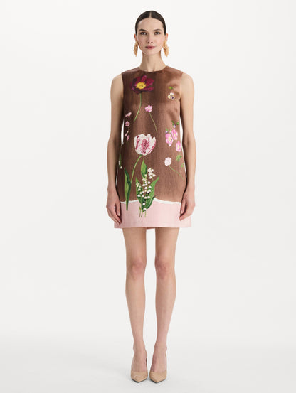 The model is wearing the mixed botanical shift dress with a border print and a sleeveless silhouette. Front view.