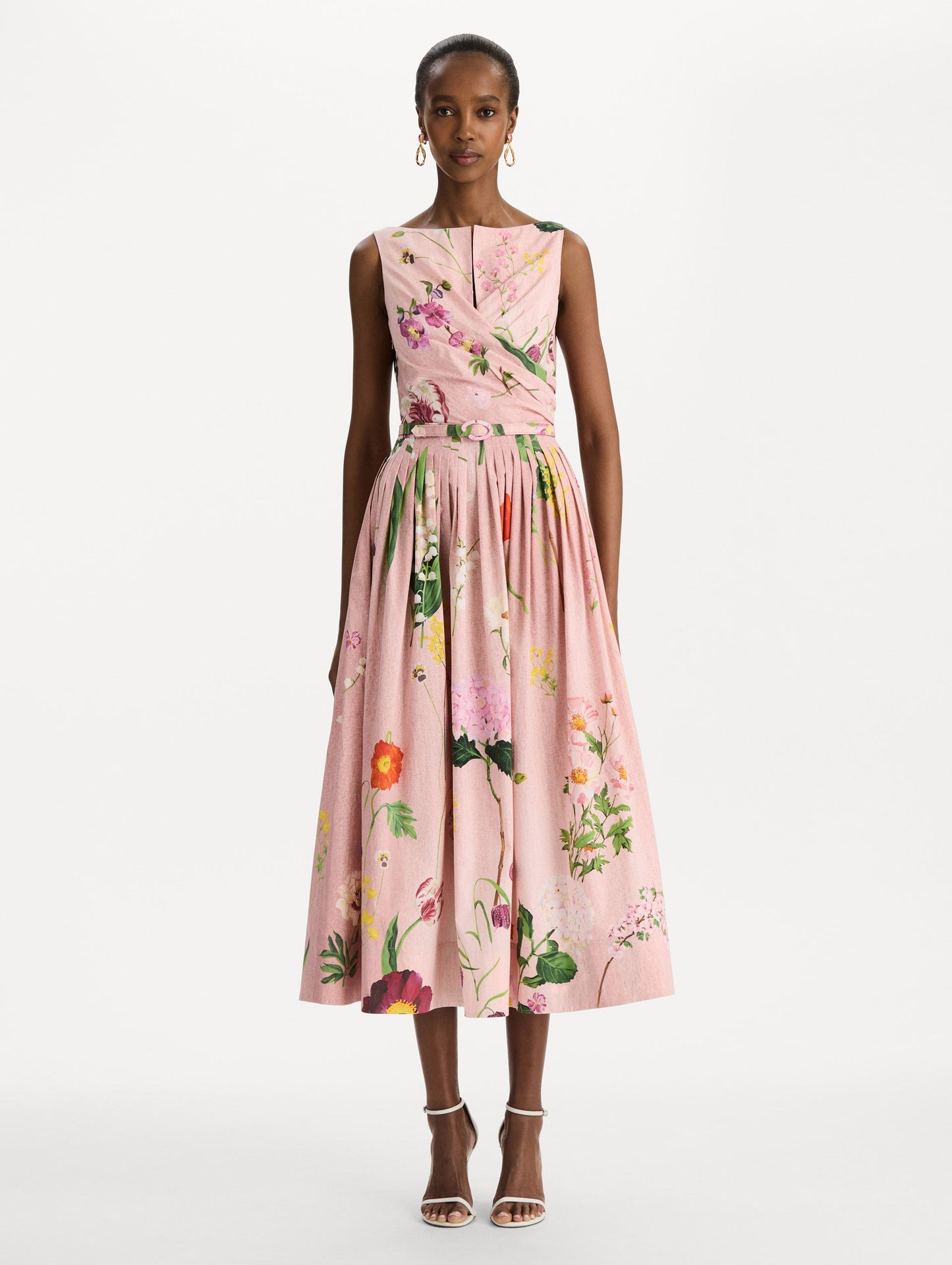 The model is wearing the mixed botanical cotton poplin draped dress with waist detailing and an all-over floral print in blush multi. Front view.