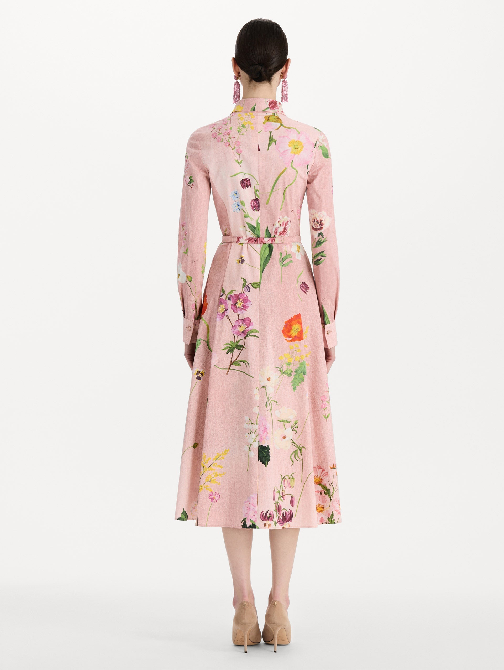 The model is wearing the mixed botanical cotton poplin dress with a collared neckline, long sleeves, and an all-over floral print in blush multi. Back view.