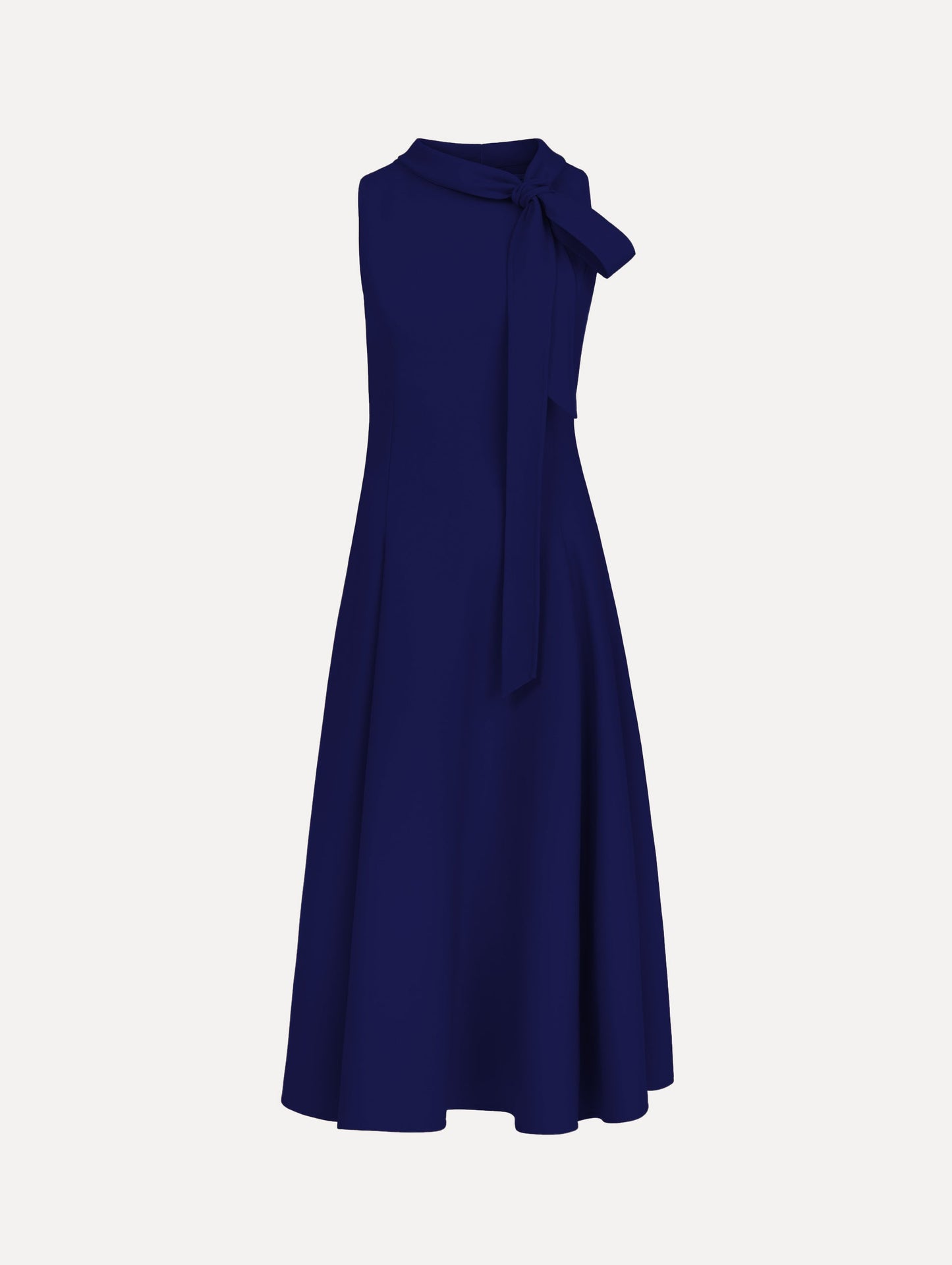 The model is wearing the Bow-Detailed Wool Dress with a sleeveless silhouette in the color navy.