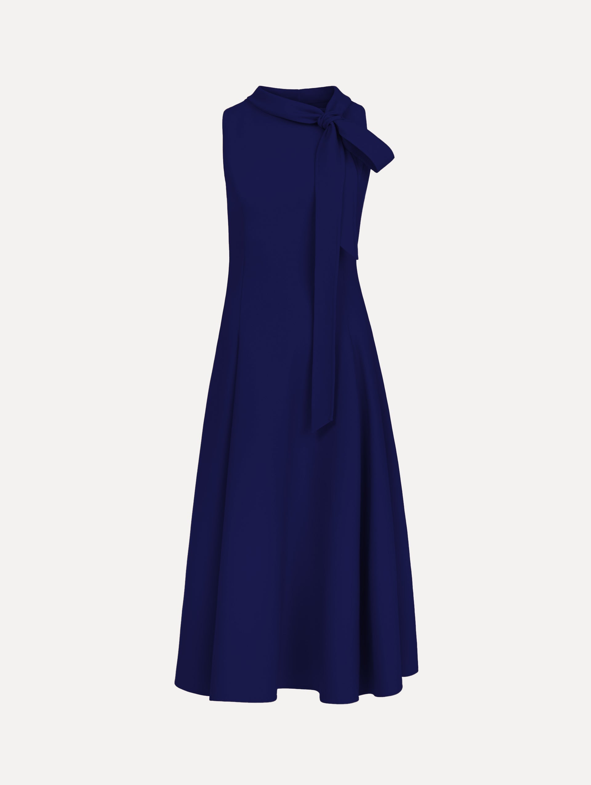 The model is wearing the Bow-Detailed Wool Dress with a sleeveless silhouette in the color navy.