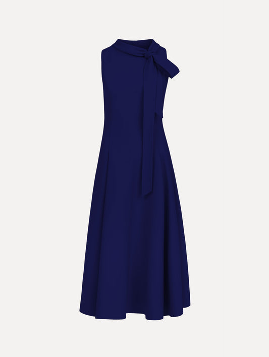 The model is wearing the Bow-Detailed Wool Dress with a sleeveless silhouette in the color navy.