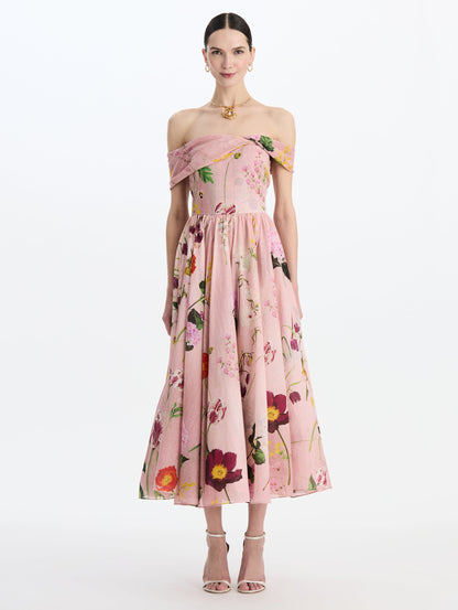 The model is wearing the mixed botanical off-shoulder dress in organic cotton with a floral print in a blush multi palette. Front view.