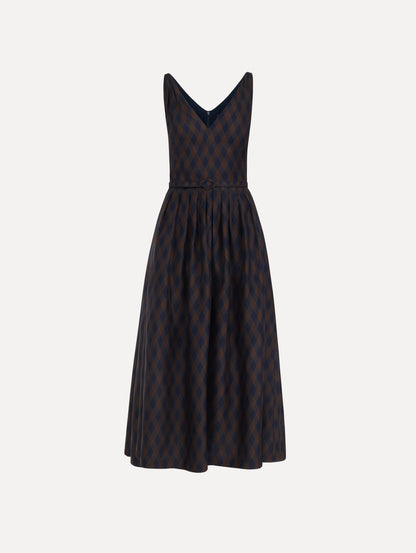 The model is wearing the argyle silk twill dress with a sleeveless silhouette, a V-neckline, and an argyle print in navy and brown.