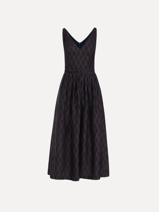 The model is wearing the argyle silk twill dress with a sleeveless silhouette, a V-neckline, and an argyle print in navy and brown.