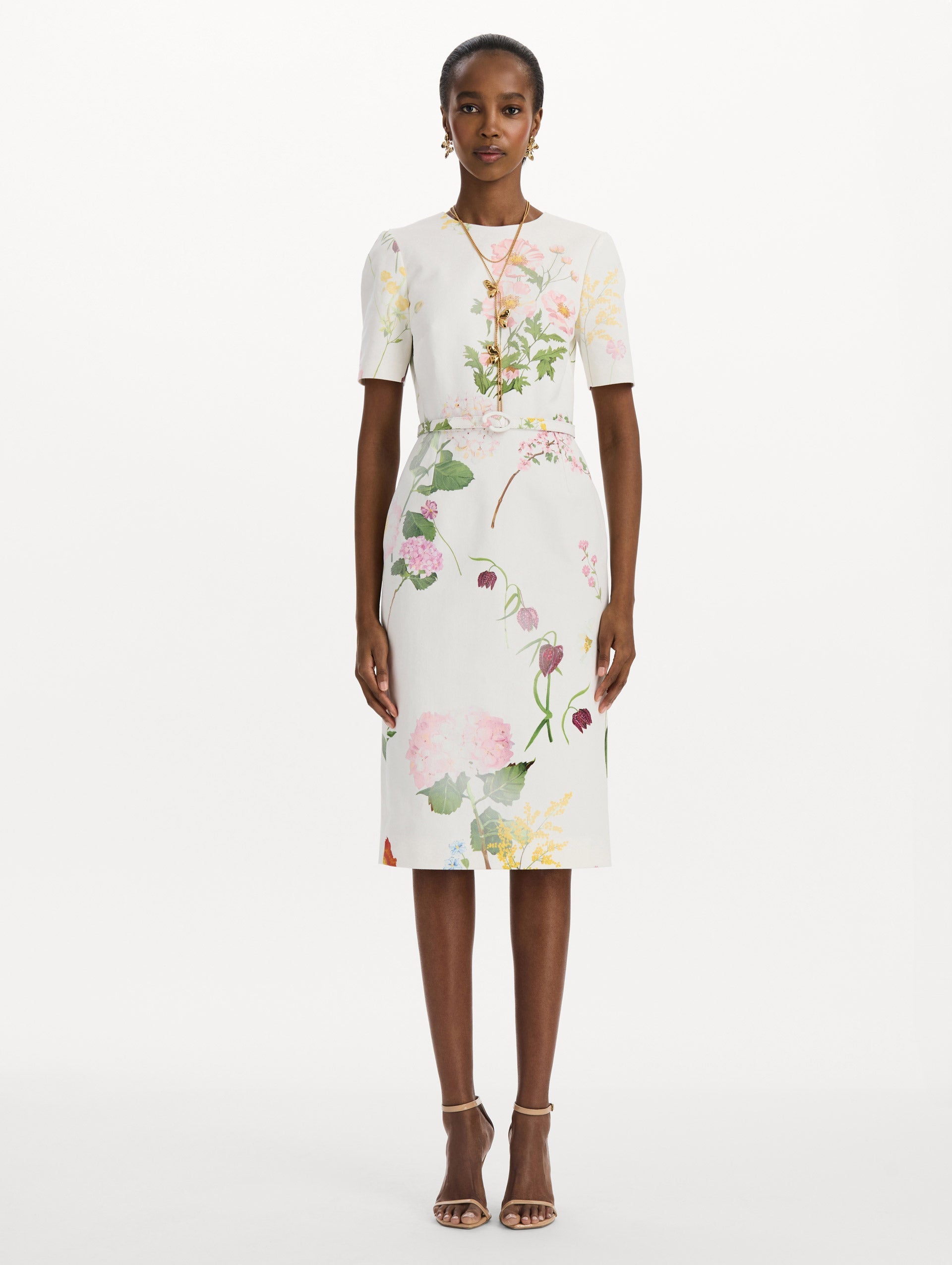 The model is wearing the faded mixed botanical denim dress with midi sleeves and a washed floral print in white multi. Front view.
