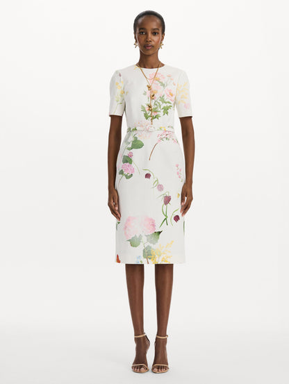 The model is wearing the faded mixed botanical denim dress with midi sleeves and a washed floral print in white multi. Front view.