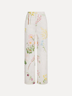 The model is wearing the faded mixed botanical denim pant with a washed floral print in cotton denim.