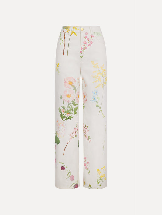 The model is wearing the faded mixed botanical denim pant with a washed floral print in cotton denim.