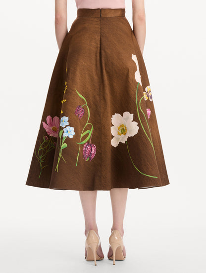The model is wearing the mixed botanical midi skirt with an all-over floral print in stretch cotton. Back view.