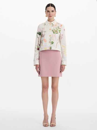 The model is wearing the faded mixed botanical denim jacket in the color white multi. Front view.