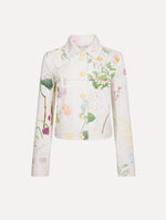 The model is wearing the faded mixed botanical denim jacket in the color white multi.