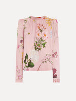 The model is wearing the mixed botanical tie-detailed blouse with a tie neckline and an all-over floral print in a blush multi palette.