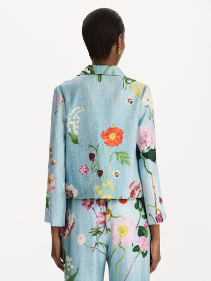The model is wearing the mixed botanical silk twill blouse with long sleeves in the color blue multi. Back view.
