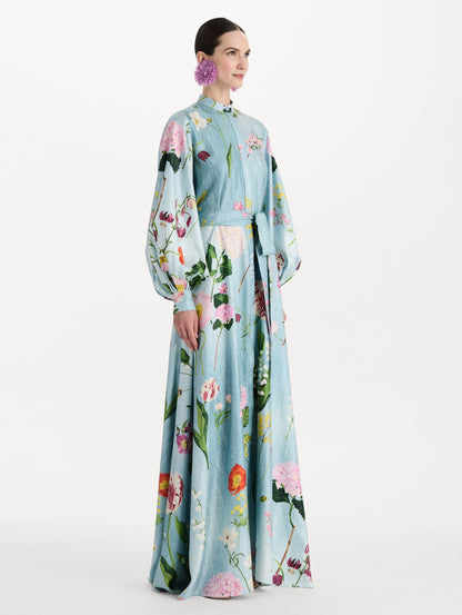 The model is wearing the mixed botanical silk twill caftan with long sleeves in blue multi. Side view.