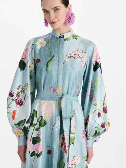The model is wearing the mixed botanical silk twill caftan with long sleeves in blue multi. Zoom view.