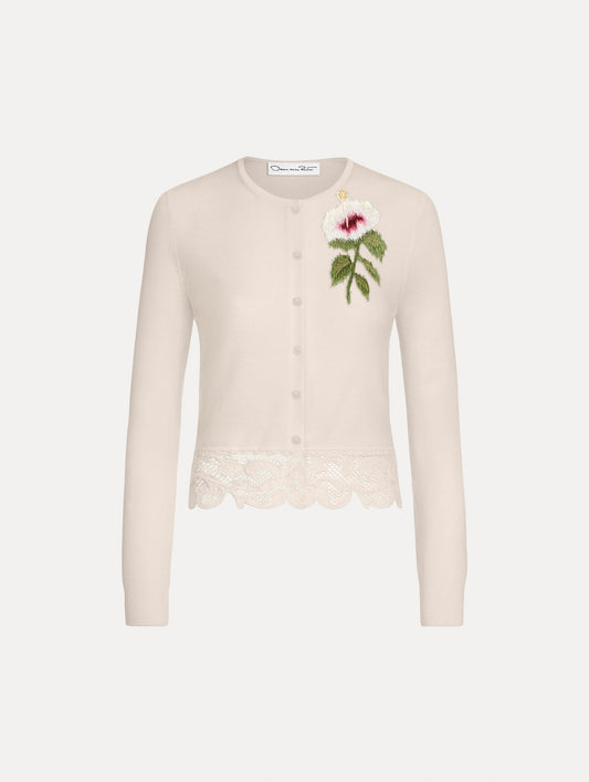 The Chiné Hibiscus Threadwork Cropped Cardigan in Ivory. Featuring a threaded Chiné hibiscus and intricate guipure lace trim. Front View.