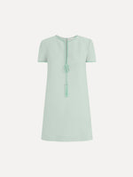 The Beaded Bow-Detail Shift Dress in Saltwater Blue. Featuring a beaded bow detail at the neckline with tassel ties and subtle trim along the edges. Front View.