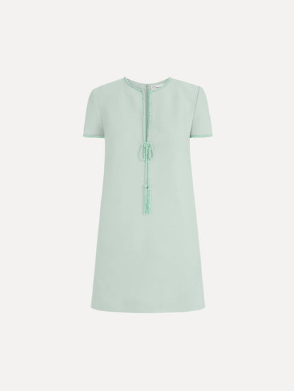The Beaded Bow-Detail Shift Dress in Saltwater Blue. Featuring a beaded bow detail at the neckline with tassel ties and subtle trim along the edges. Front View.