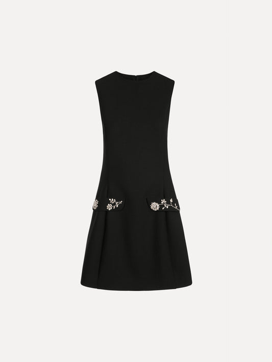 The Crystal Floral Embroidered Cocktail Dress in Black. Featuring faux front flap pockets with crystal embroidery and a structured mini skirt. Front View.
