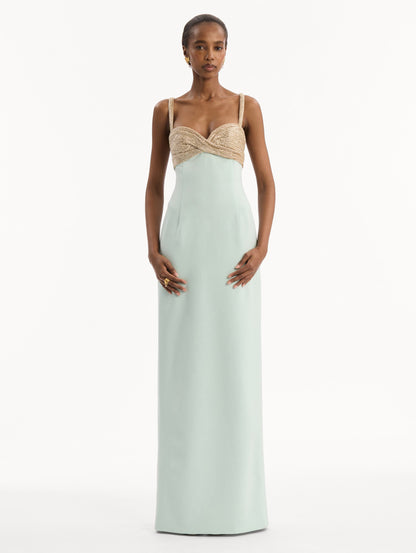 The model is wearing the Twist-Detail Metallic Column Gown in Saltwater Blue. Featuring a metallic twist-detail bodice and long, column silhouette. Front View.