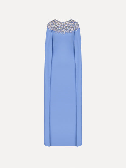The Crystal & Glass Embroidered Caftan in a hydrangea blue color. Featuring crystal and glass bead embroidery at the collar, flowing cape-like sleeves, and a long skirt. Front View.