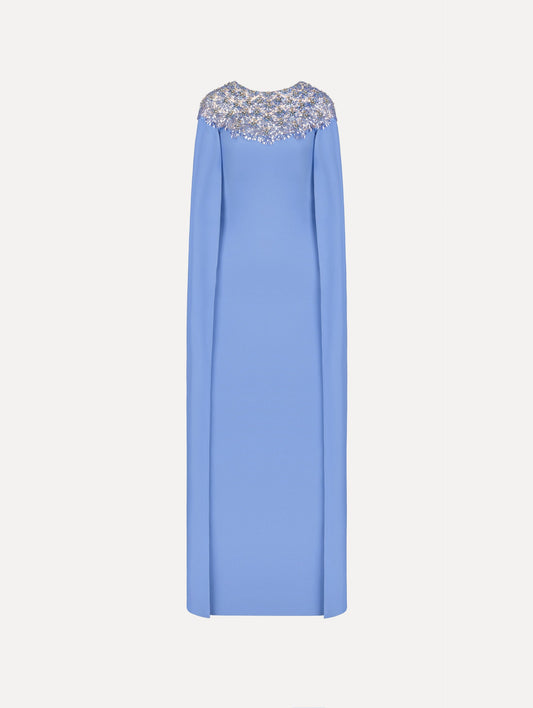 The Crystal & Glass Embroidered Caftan in a hydrangea blue color. Featuring crystal and glass bead embroidery at the collar, flowing cape-like sleeves, and a long skirt. Front View.
