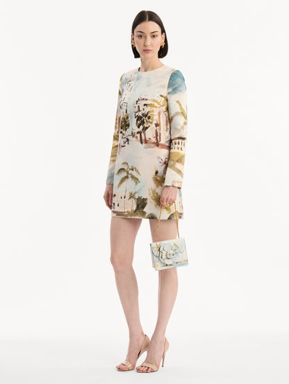 The model is wearing the Dominican Landscape Printed Mini TRO Bag in Saltwater Blue. Full-Body View.