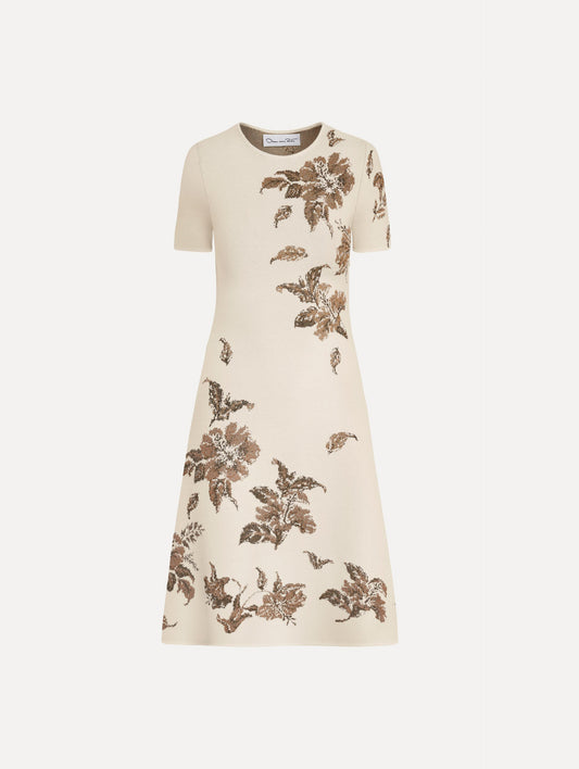 The Hibiscus Metallic Jacquard Dress in Ivory with Gold hibiscus motifs. Featuring short sleeves, a softly structured silhouette, and mini-length skirt. Front View.